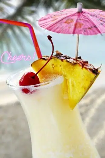 Close up of Pina Colada with the backdrop of a beach