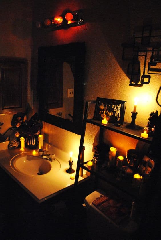 Candles, and flameless candles easily create a spooky ambiance for Halloween Bathroom decorations be sure to remove your light bulbs