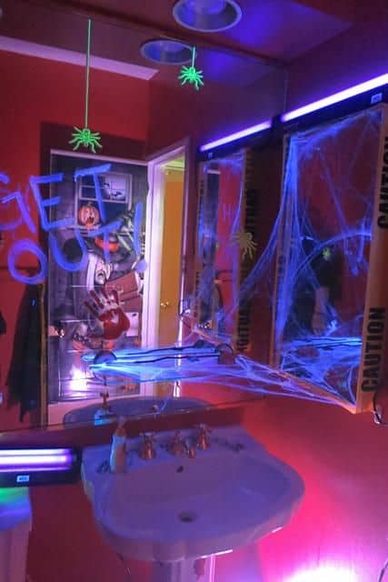 Replace bathroom lighting with black lights and bulbs to make your Halloween Bathroom decorations that much scarier