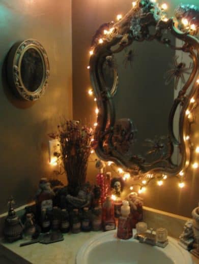 String lights create a spooky ambiance for Halloween Bathroom Decorations just be sure to take out your light bulbs