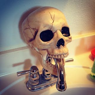 Easy diy Halloween Bathroom decorations for the faucet using a dollar store skull