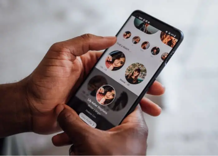 man holding cell phone on dating app