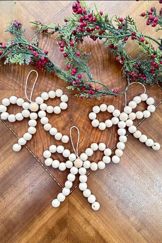 These rustic wood bead bow ornaments are an easy and festive DIY Christmas craft to make or sell, perfect for farmhouse-style holiday décor.
