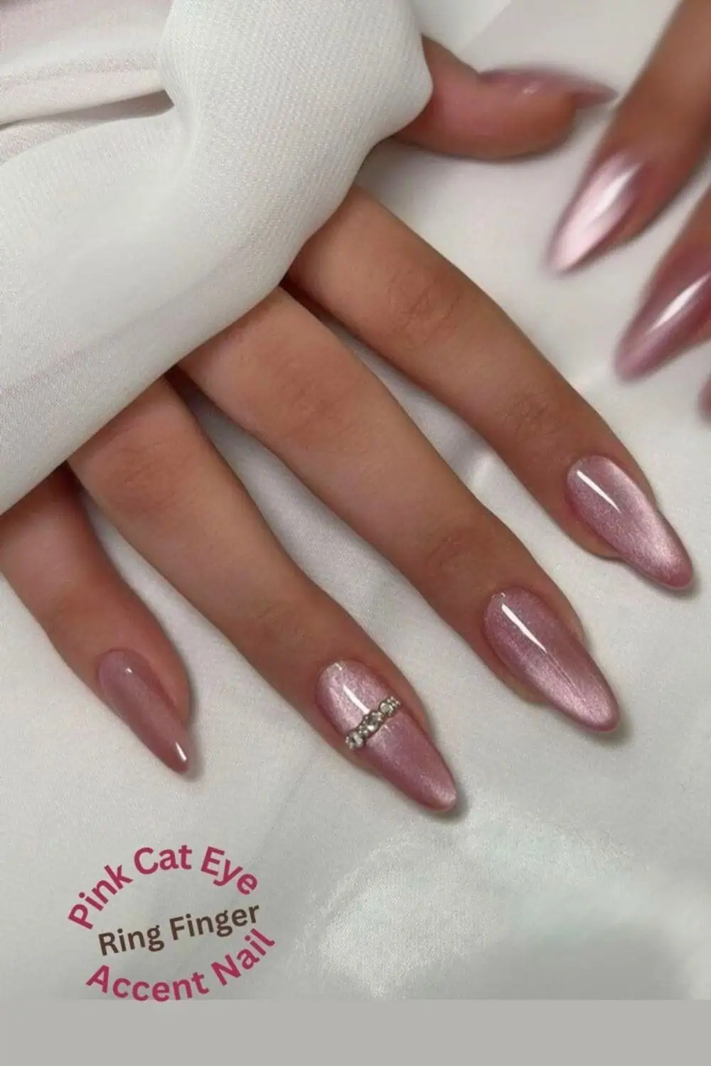 Close-up of pink cat eye nails with a glossy, shimmery finish and a diamond accent design on the ring finger, perfect for cute spring and summer nail ideas, pink nails trends, and elegant wedding nails.