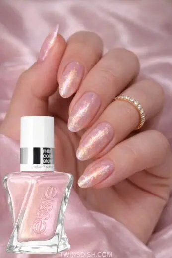 Essie Gel Couture Liquid Diamonds nail polish in Frost Yourself shade on almond shaped nails with iridescent pink chrome shimmer, trendy spring nail colors 2026