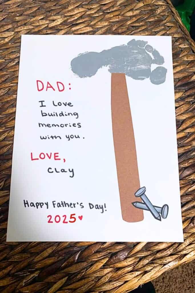 Father's Day Foot Print card with the foot print in grey as the Hammer with a sentimental message to Dad from a baby or toddler