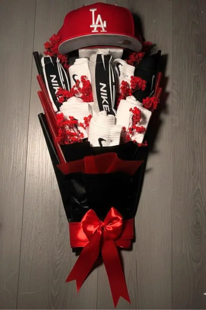 Red and black hat bouquet with LA baseball cap, Nike socks, and sports accessories gift arrangement for men