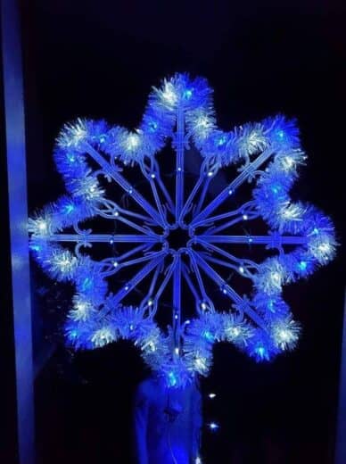 Easy DIY Dollar Store Coat Hanger Snowflake with garland and lights for indoor and outdoor Christmas Decorations