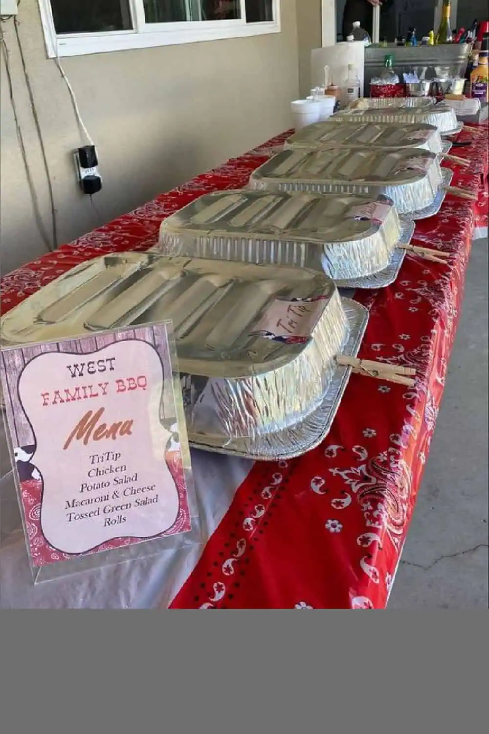 disposable aluminum pans covering food with a clothespin holding them in place on a western bbq Grad party food table