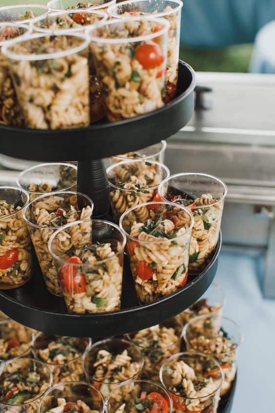 Macaroni salad in plastic cups on a black  3 tier display for Graduation Party