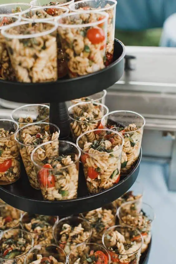 Macaroni salad in plastic cups on a black  3 tier display for Graduation Party