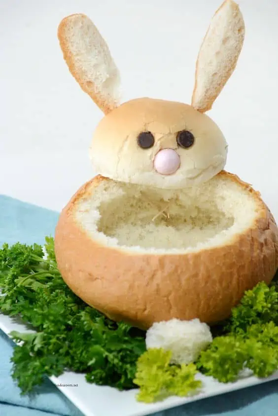 Bunny bread bowl with chocolate chip eyes on a bed of lettuce
