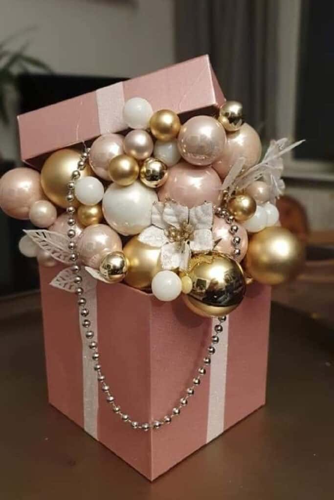 Pink Diy Christmas box decoration filled with pink, gold, and white Christmas ornaments