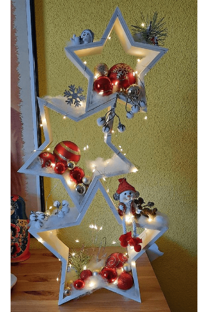 Diy lighted white stacked Christmas stars decoration on a table