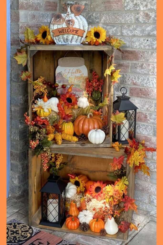 Best Fall Decor for the home using wood crate pumpkins, lanterns, and fall leaves