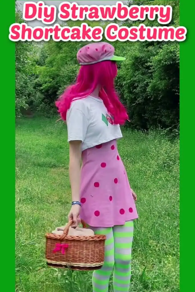 Diy Strawberry Shortcake Halloween costume on a girl in a grassy area with a picnic basket