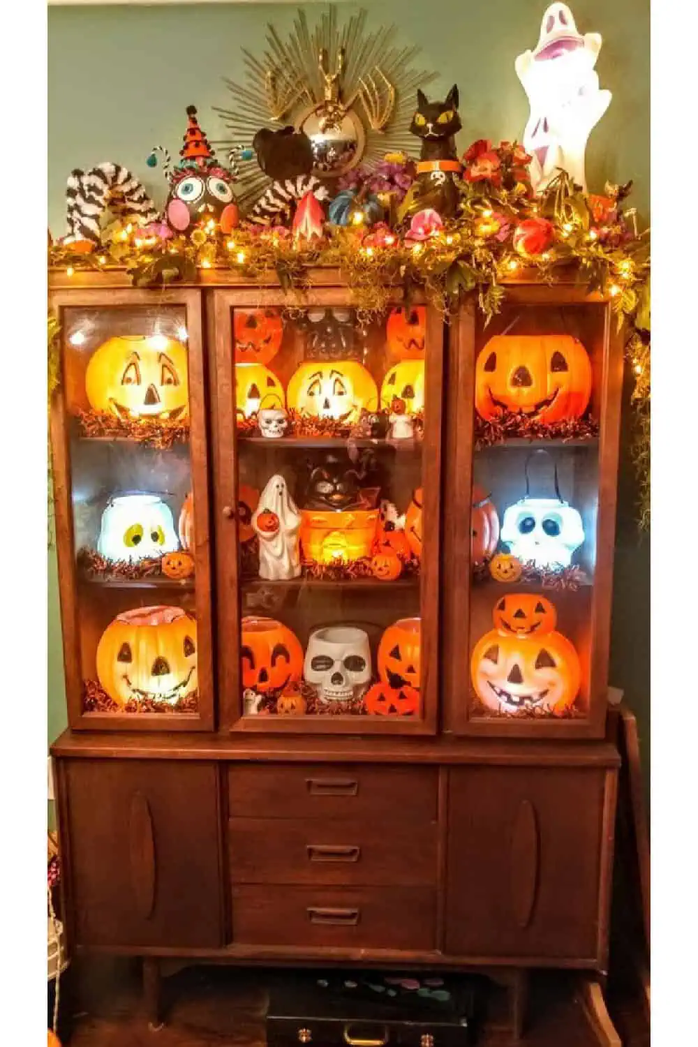 DIY Halloween decorations for a cozy home hutch in dining room full of vintage pumpkins