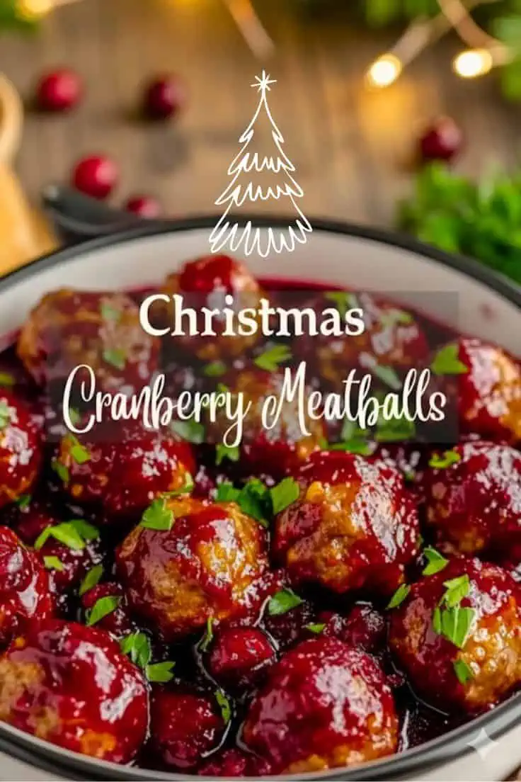 Christmas cranberry meatballs glazed in a sweet and tangy cranberry sauce, garnished with fresh herbs and served as an easy holiday appetizer.