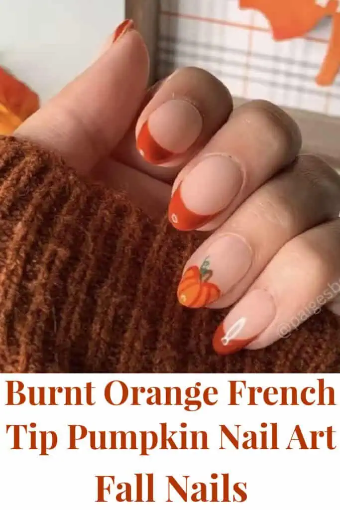 Burnt orange French tip fall nails with pumpkin nail art accent. Trendy autumn manicure featuring cozy fall colors and seasonal pumpkin design, perfect for Thanksgiving or Halloween nail inspiration.