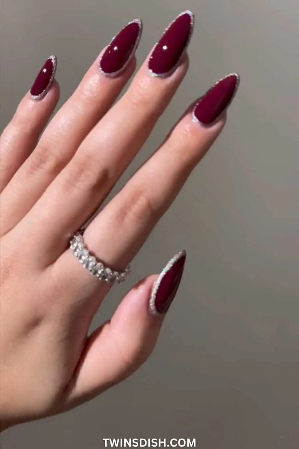 Black cherry red nails with glitter design around the edge