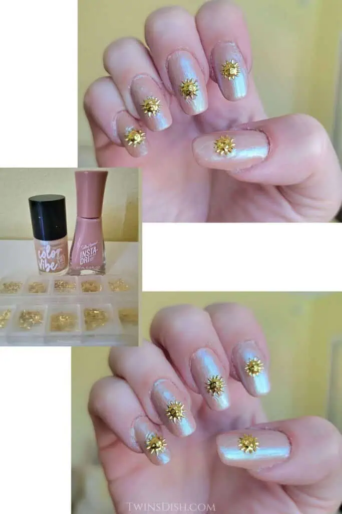 Short natural nails painted with pearly nude iridescent polish and decorated with small gold sun charms for an end-of-summer manicure.