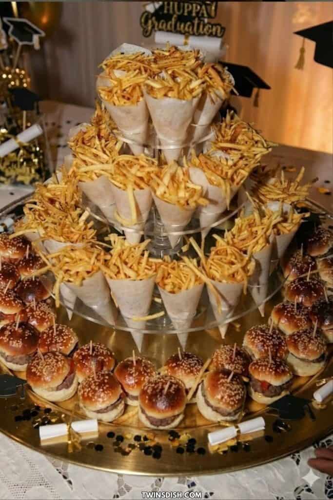 Graduation party food display with sliders and fries served buffet-style on a tiered stand