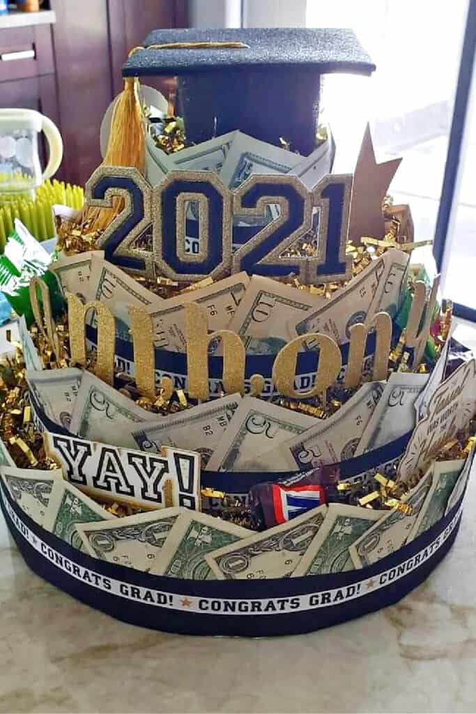 Easy Diy 4 tier money cake with candy accents and a Graduation cap topper for Graduation Gift