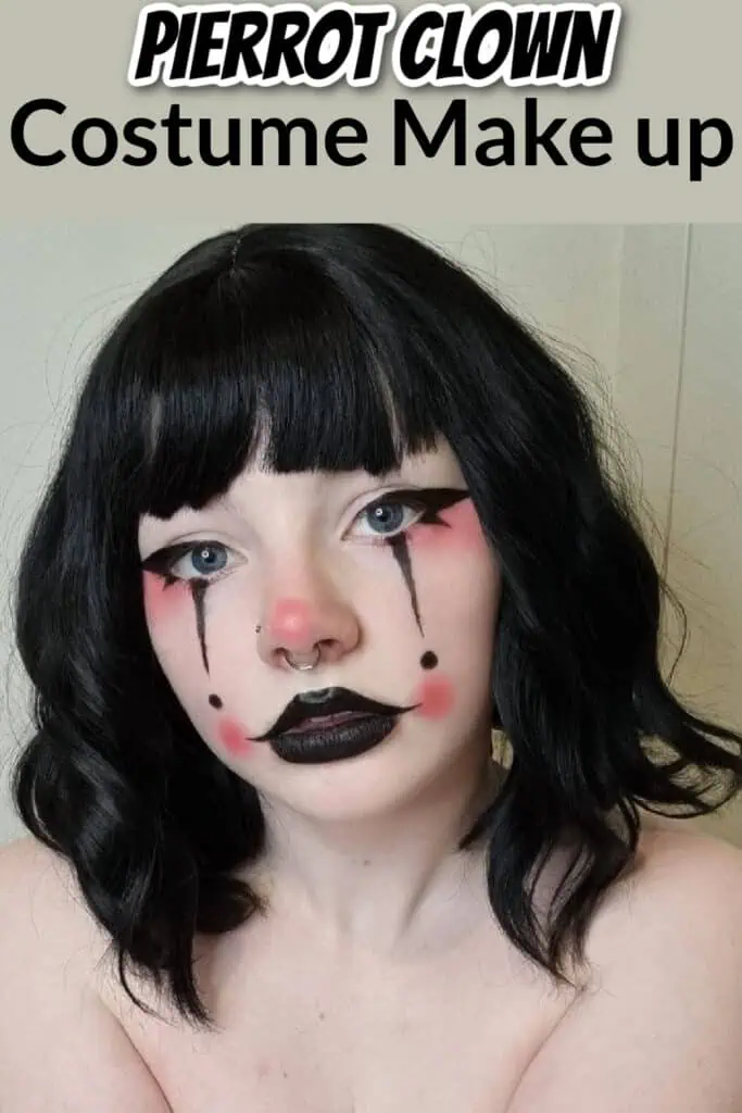 Close-up of a woman wearing Pierrot clown makeup with dramatic black lipstick, teardrop eyeliner, rosy cheeks, and short black hair — creative Halloween or costume makeup idea.