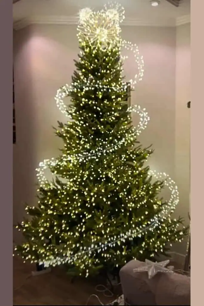 Magical spiral Christmas tree decorated with twinkle LED lights and a glowing burst topper—viral DIY lighting idea for 2025 holiday decor and tree inspiration.