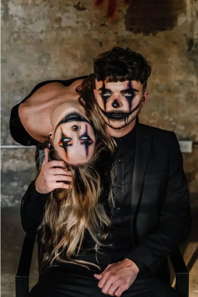 Creepy clown joker Halloween costume with sinister face paint, dark eye makeup, and spooky smile design.