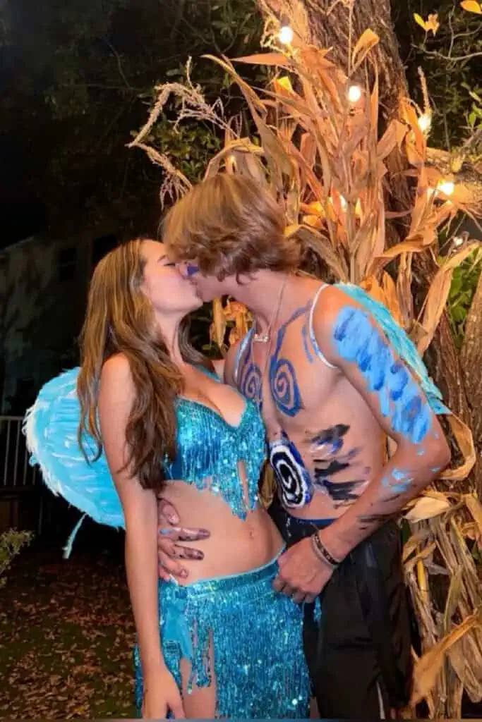 Couple dressed as Rio birds for Halloween, featuring sparkly blue costumes with wings, body paint, and tropical-inspired details. Creative and unique couples costume idea inspired by the animated movie Rio.