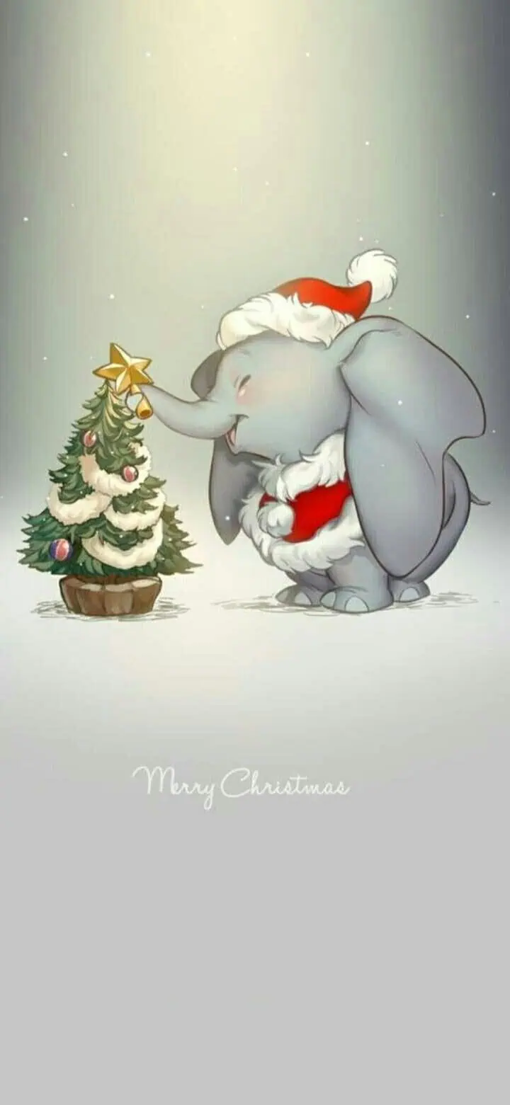 Disney’s Dumbo Christmas iPhone wallpaper featuring the beloved elephant in a Santa hat and red coat. Dumbo smiles while decorating a Christmas tree with a golden star as snow falls softly in the background with “Merry Christmas” text. A cute and festive holiday phone background perfect for Disney fans looking for Christmas iPhone wallpapers.