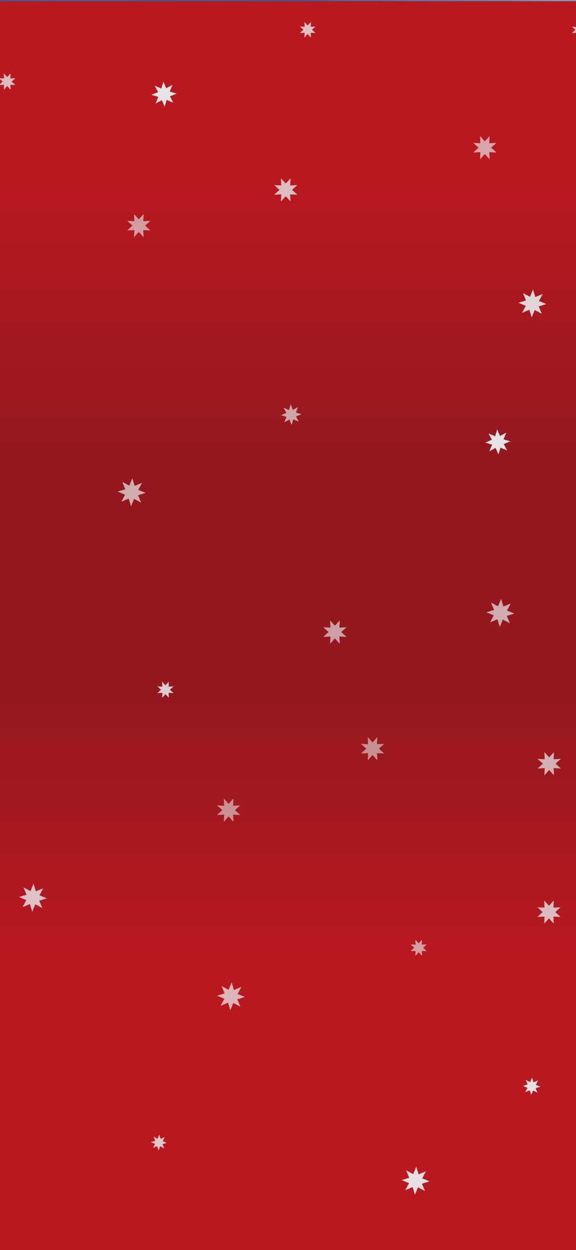 Minimalist red Christmas wallpaper with small white snowflake stars scattered across a festive red gradient background. A classic holiday iPhone wallpaper with a simple, elegant Christmas design.
