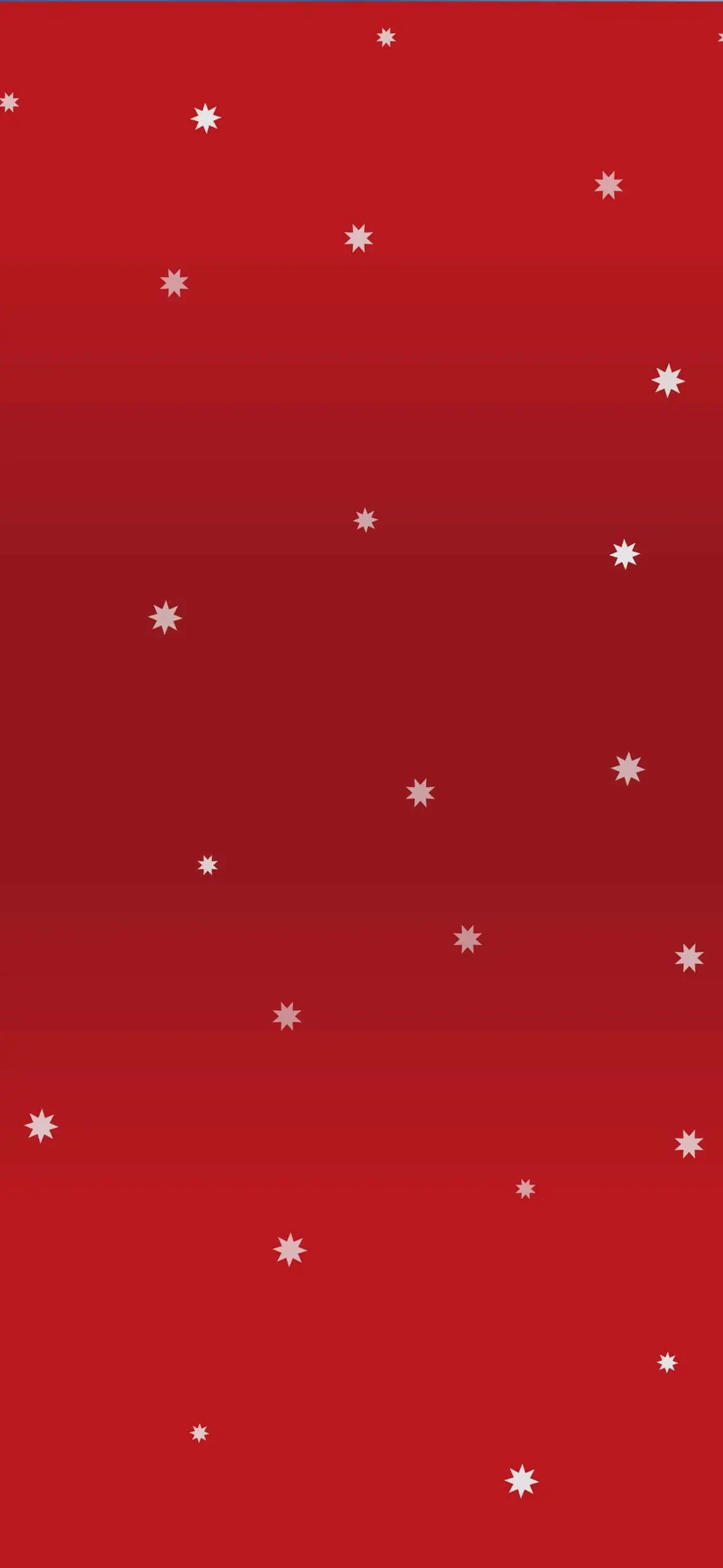 Minimalist red Christmas wallpaper with small white snowflake stars scattered across a festive red gradient background. A classic holiday iPhone wallpaper with a simple, elegant Christmas design.
