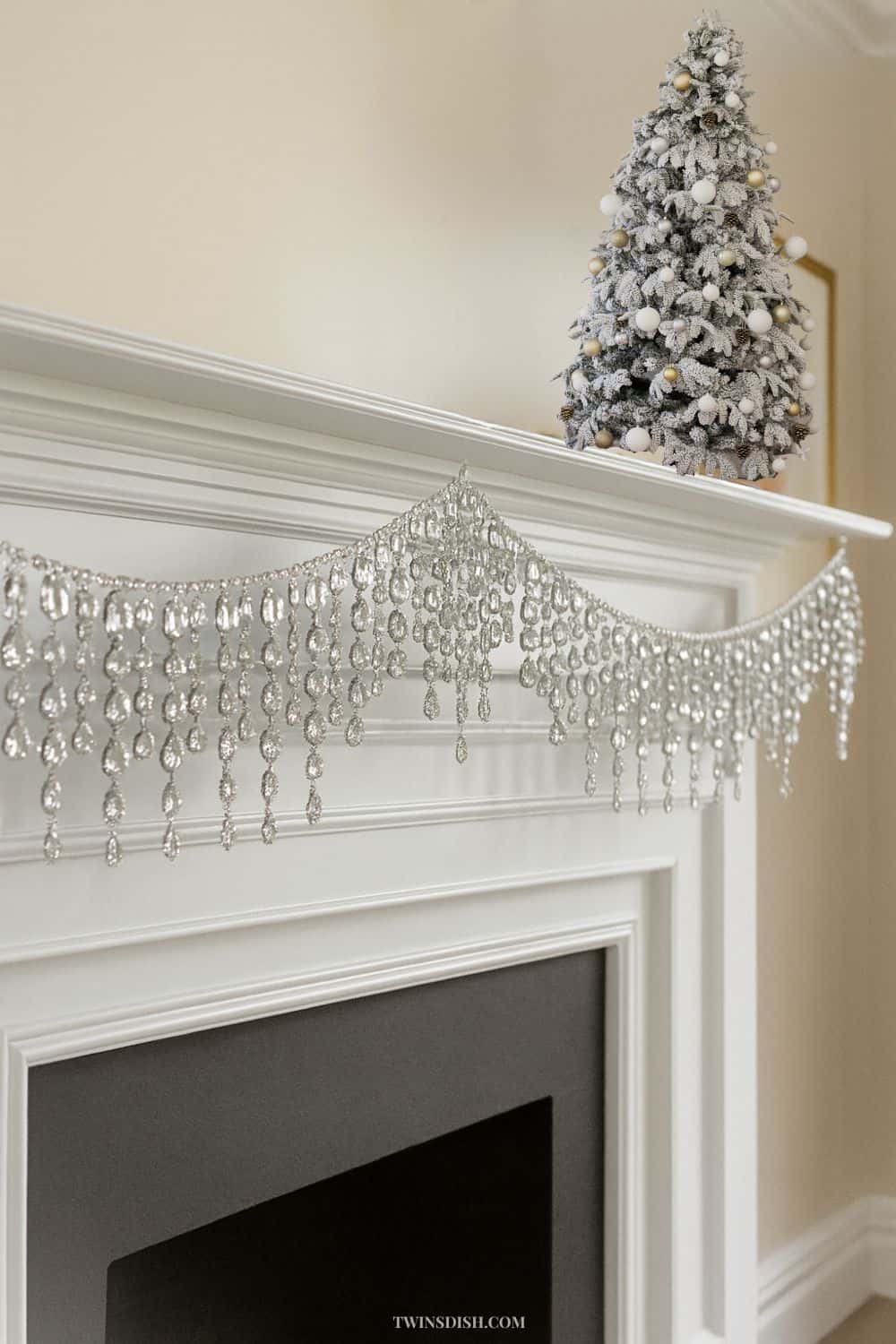 Elegant luxury Christmas fireplace decorated with a rhinestone garland and evergreen greenery, showcasing a glamorous holiday decor trend