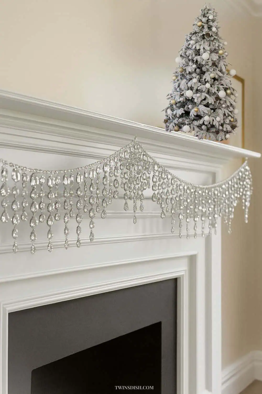 Elegant luxury Christmas fireplace decorated with a rhinestone garland and evergreen greenery, showcasing a glamorous holiday decor trend