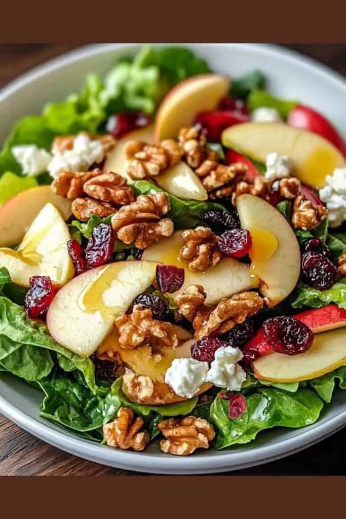 A fresh Thanksgiving salad made with crisp apples, walnuts, cranberries, spinach, and feta, drizzled with honey dressing — a quick and easy 15-minute recipe that looks and tastes gourmet.