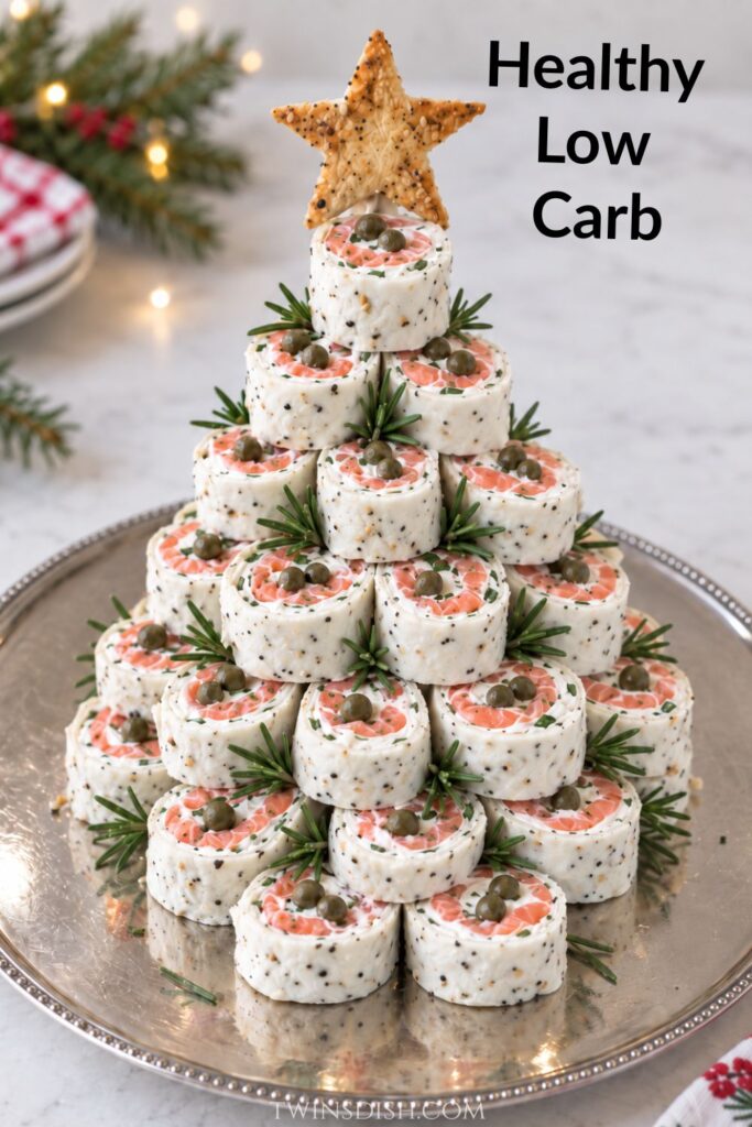 Healthy smoked salmon pinwheel Christmas tree made with white Egglife Everything Bagel wraps, low-fat cream cheese, capers, chives, and rosemary.
