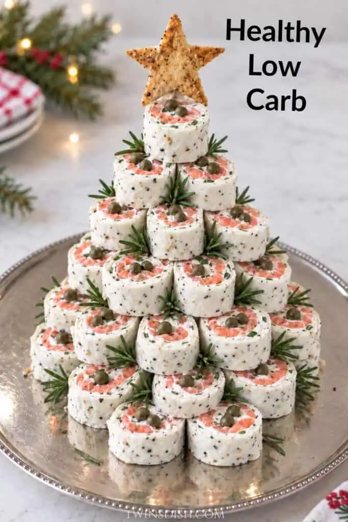 Healthy smoked salmon pinwheel Christmas tree made with white Egglife Everything Bagel wraps, low-fat cream cheese, capers, chives, and rosemary.