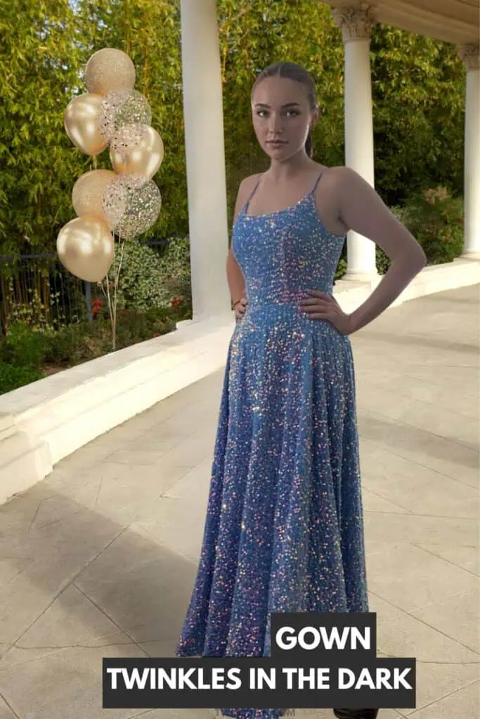 Teen girl wearing sparkly blue sequin prom dress with thin straps and flowing skirt standing at outdoor prom venue with gold balloons.