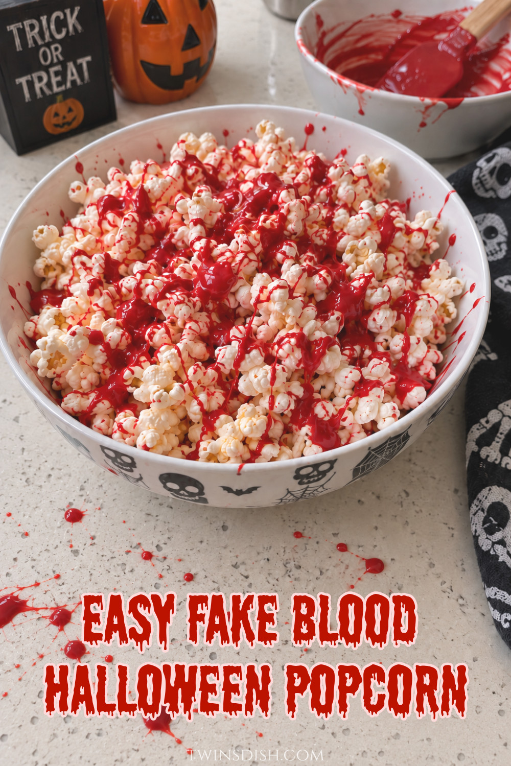 Easy fake blood Halloween popcorn made with popcorn drizzled in red-colored white chocolate for a spooky Halloween party snack