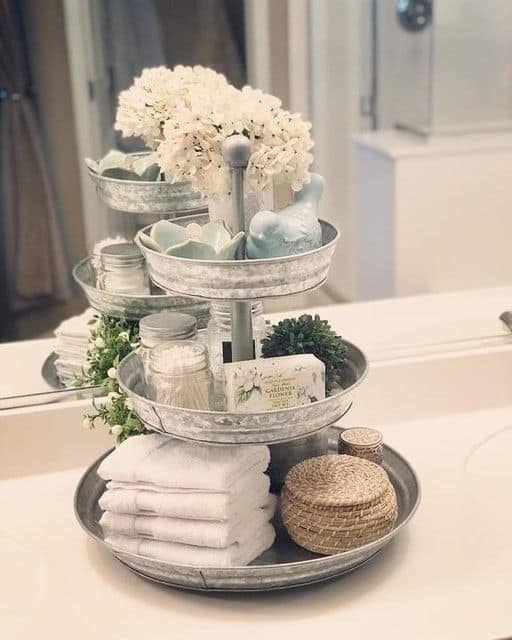 The best easy DIY Farmhouse small Bathroom decor ideas on a budget for apartments using glavanized tiered trays to organize counter top and provide storage