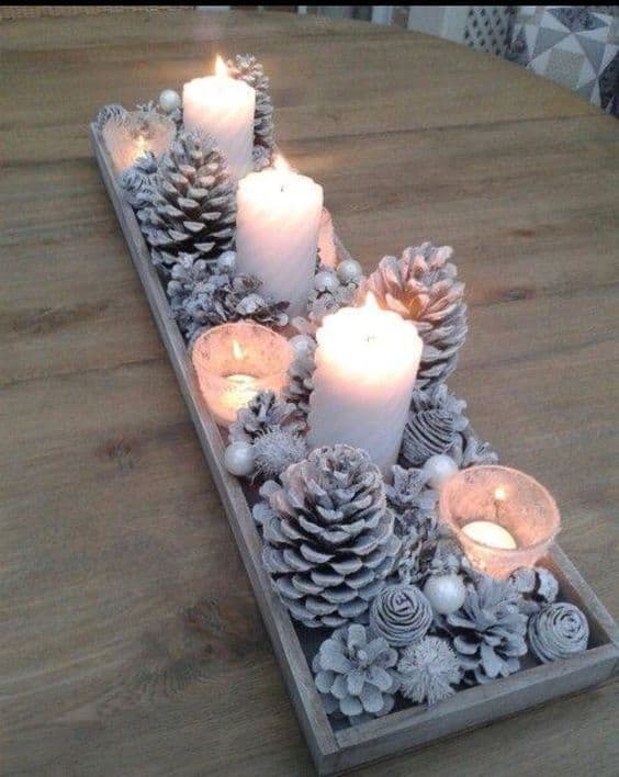 Breathtaking Farmhouse Glam Christmas Decor Ideas that'll transform your home - Rustic yet elegant winter painted pinecone centerpiece craft idea with candles #snowflakes