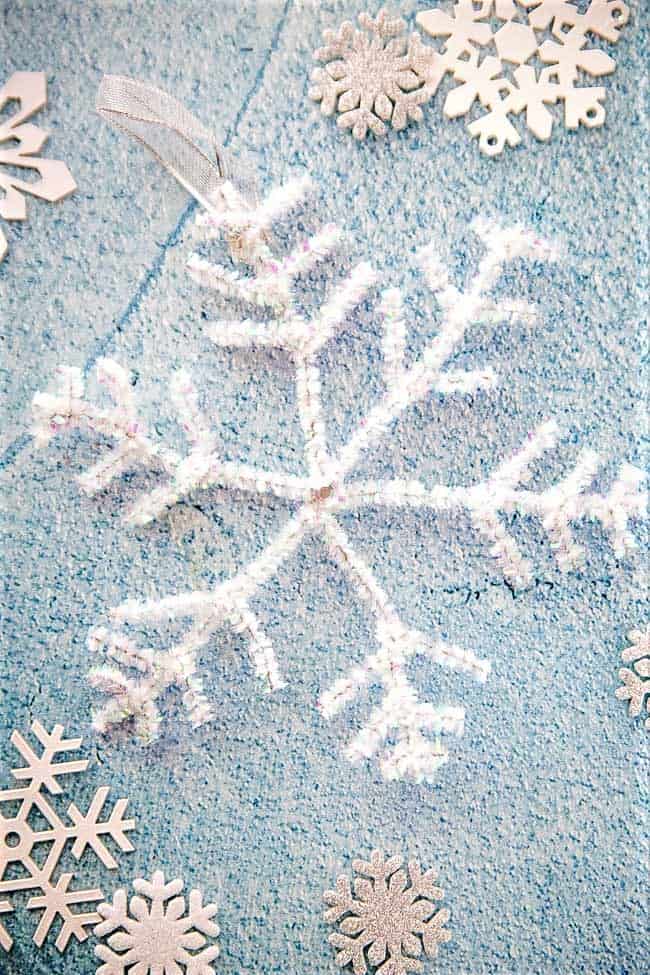 Easy DIY Snowflakes and garland made out of pipe cleaners. Simple yet beautiful dollar store craft idea anyone can make, even kids for a party, wedding, or gift.