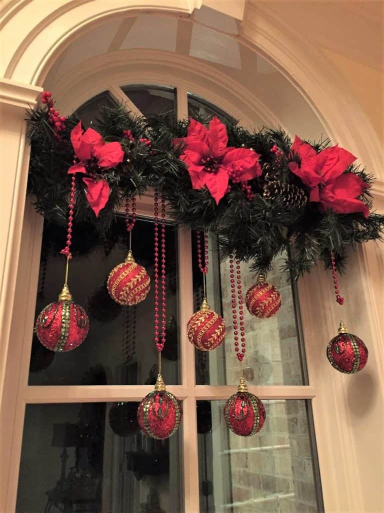 Easy DIY hanging window ornaments using ribbon and garland. Elegant Christmas decoration idea for mantle, window, ceiling, or wall. Great budget decor idea for the home, winter wedding, or Christmas party.