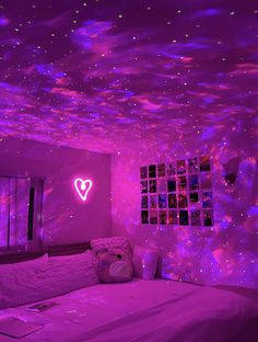 Galaxy star projector and neon heart sign in teen bedroom