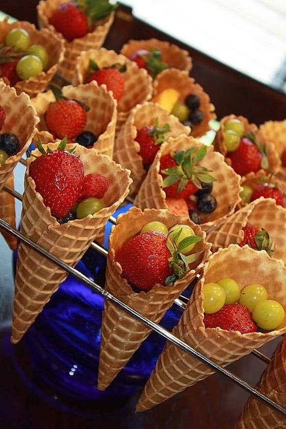 Best Easy DIY 4th of July Party food ideas. Fruit cones are a fun summer treat that are sure to be a hit at your party.