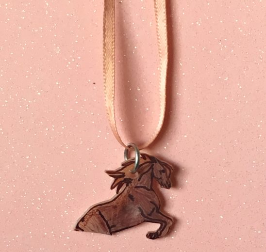 This Shrinky dink necklace is the first DIY Mother's Day gift we ever made for our Mom. It's such a fun craft kids can make!