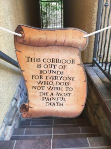 The Easiest, Most Creative, and Best Halloween Party Decorations That'll Keep Guests Out of bedrooms and in the party zone Using a Harry Potter print Out and Piece of String. Great dollar store idea.