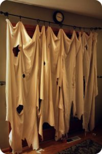 The best, easiest, and most creative Halloween Party Decorations that'll keep guests out using an old torn sheet.